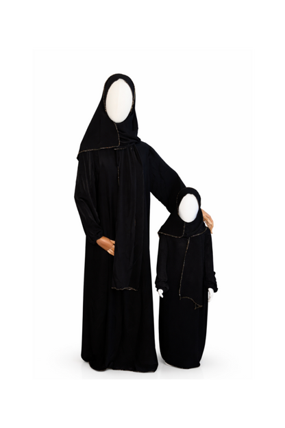 Black abaya with matching headscarf on a white background