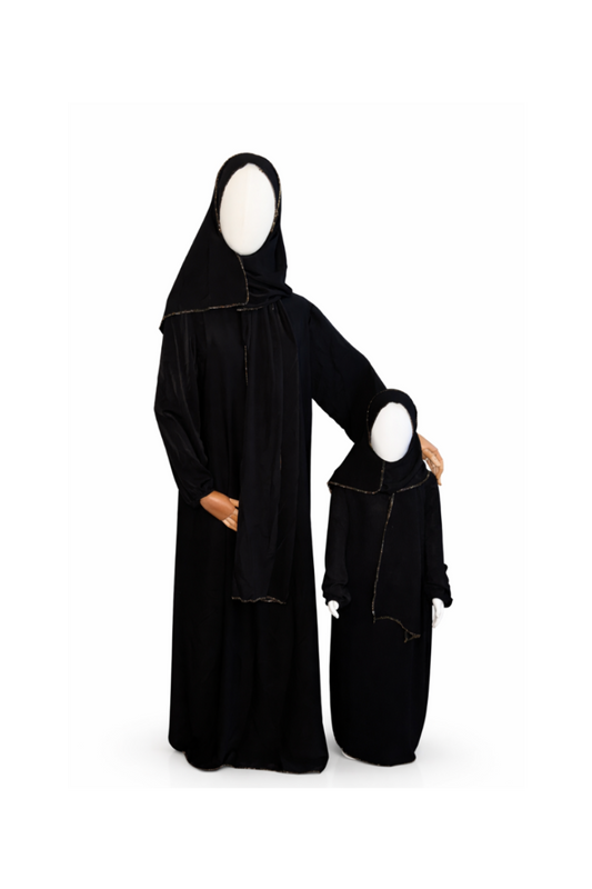 Black abaya with matching headscarf on a white background
